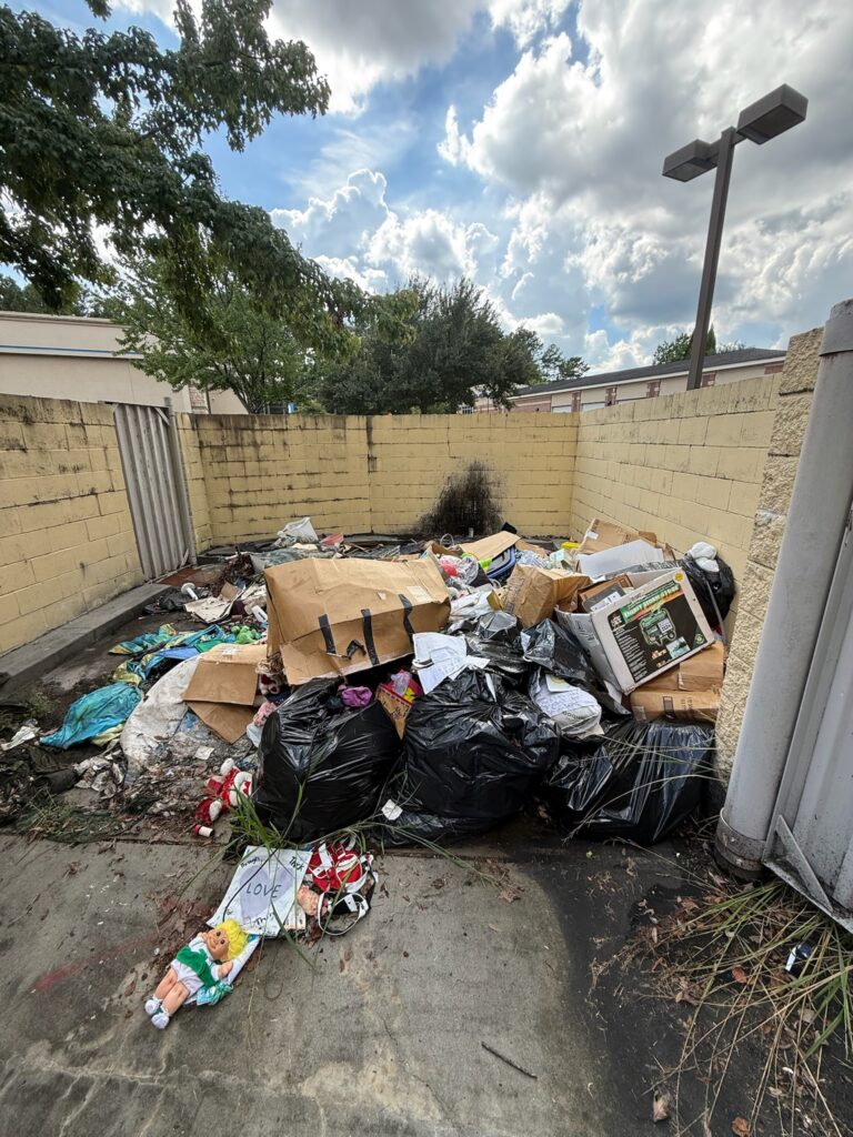 Commercial trash area before debris removal